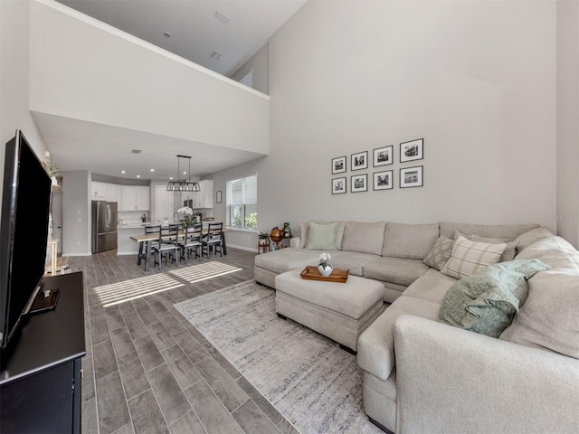 15364 Isla Palma Ln, Nokomis, FL 34275 - living area with a high ceiling, wood finished floors, and baseboards