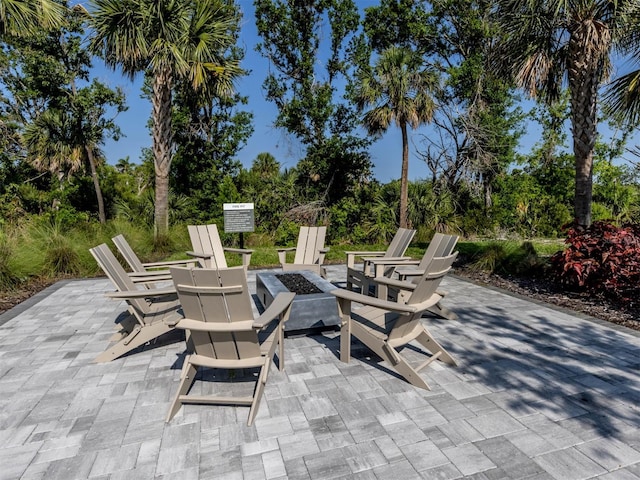 15364 Isla Palma Ln, Nokomis, FL 34275 - view of patio / terrace featuring an outdoor fire pit and view of wooded area