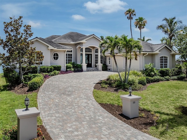 333 Sunrise Dr, Nokomis, FL 34275 - ranch-style house featuring stucco siding, a front yard, decorative driveway, and an attached garage