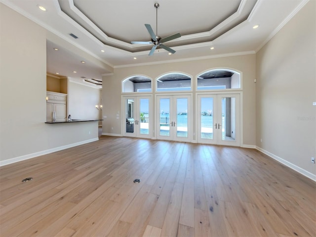 333 Sunrise Dr, Nokomis, FL 34275 - unfurnished living room with a raised ceiling, ceiling fan, recessed lighting, light wood finished floors, and crown molding