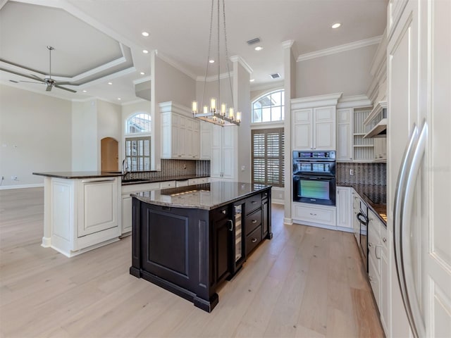 333 Sunrise Dr, Nokomis, FL 34275 - kitchen featuring refrigerator, light wood-type flooring, tasteful backsplash, recessed lighting, and ornamental molding