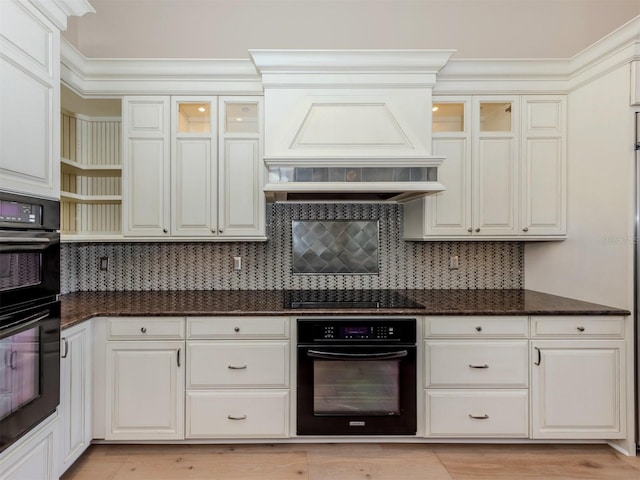 333 Sunrise Dr, Nokomis, FL 34275 - kitchen featuring premium range hood, black appliances, tasteful backsplash, dark stone countertops, and ornamental molding