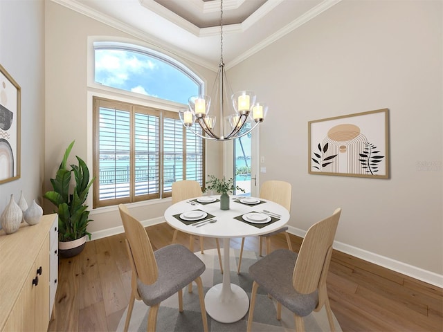 333 Sunrise Dr, Nokomis, FL 34275 - dining room with ornamental molding, a chandelier, wood finished floors, baseboards, and a raised ceiling