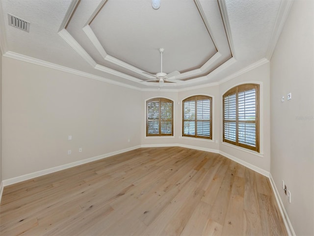 333 Sunrise Dr, Nokomis, FL 34275 - spare room featuring a tray ceiling, ornamental molding, light wood-style flooring, baseboards, and a ceiling fan