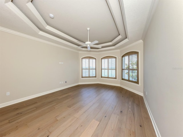 333 Sunrise Dr, Nokomis, FL 34275 - spare room with a tray ceiling, wood finished floors, crown molding, ceiling fan, and baseboards