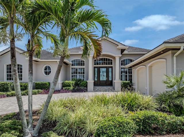 333 Sunrise Dr, Nokomis, FL 34275 - view of front of property with french doors, stucco siding, and a garage