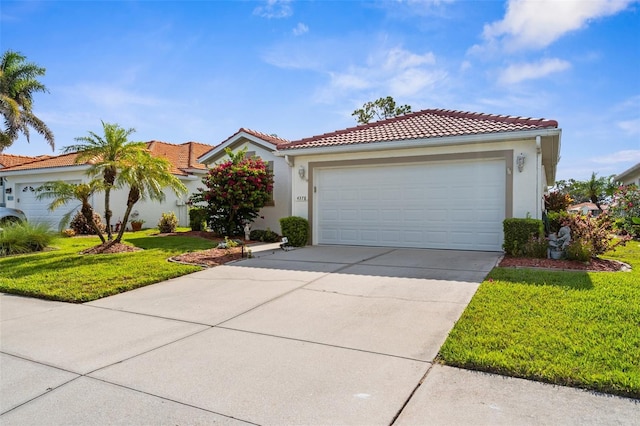 4378 Summertree Rd, Venice, FL 34293 - mediterranean / spanish-style house featuring driveway, stucco siding, a front lawn, a tile roof, and an attached garage
