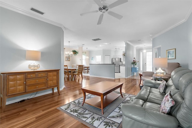 4378 Summertree Rd, Venice, FL 34293 - living area featuring ceiling fan, light wood-type flooring, healthy amount of natural light, ornamental molding, and baseboards