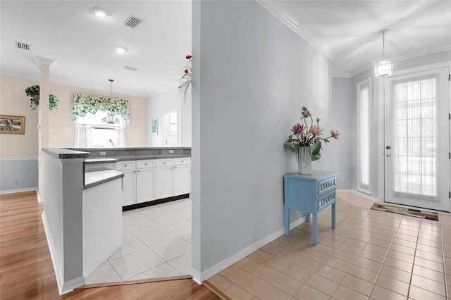 4378 Summertree Rd, Venice, FL 34293 - kitchen featuring dark countertops, white cabinets, ornamental molding, baseboards, and pendant lighting