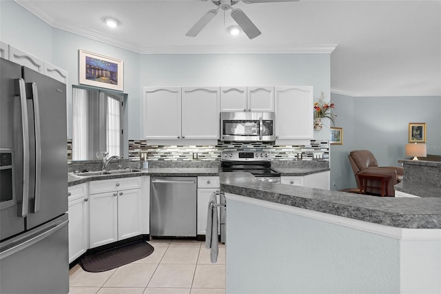 4378 Summertree Rd, Venice, FL 34293 - kitchen featuring appliances with stainless steel finishes, a sink, crown molding, and white cabinetry