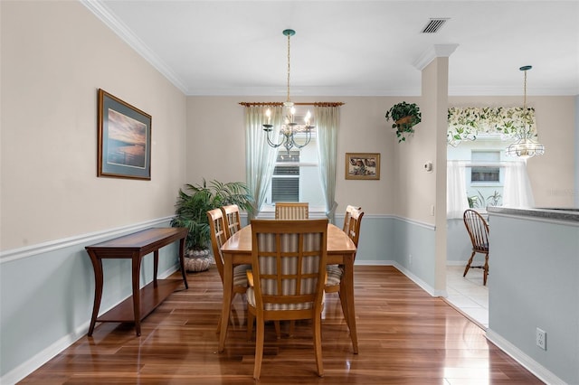 4378 Summertree Rd, Venice, FL 34293 - dining room with a chandelier, wood finished floors, crown molding, and baseboards
