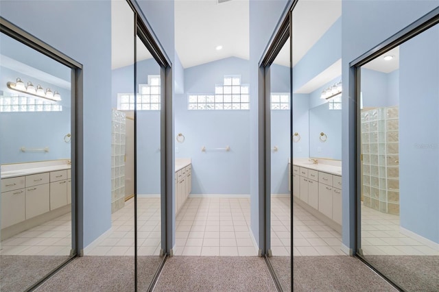 4378 Summertree Rd, Venice, FL 34293 - full bath with two vanities, lofted ceiling, and tile patterned floors