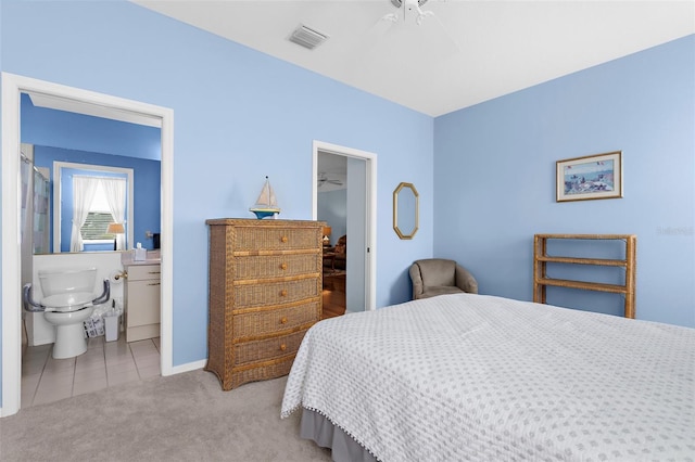 4378 Summertree Rd, Venice, FL 34293 - bedroom featuring light colored carpet, a walk in closet, light tile patterned flooring, ensuite bath, and baseboards