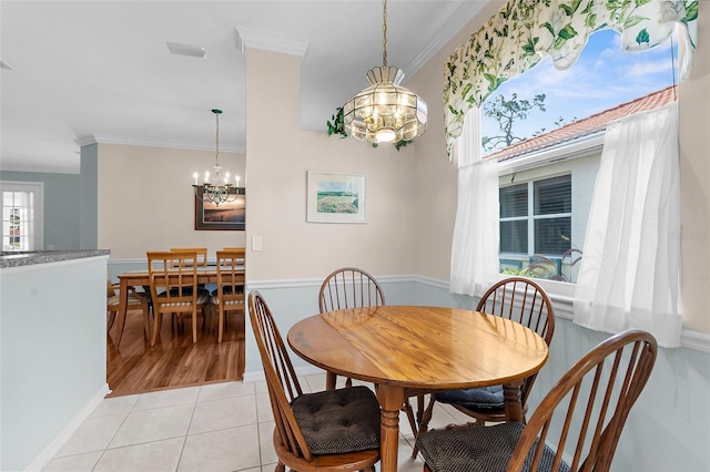 4378 Summertree Rd, Venice, FL 34293 - dining space featuring a chandelier, ornamental molding, and light tile patterned flooring