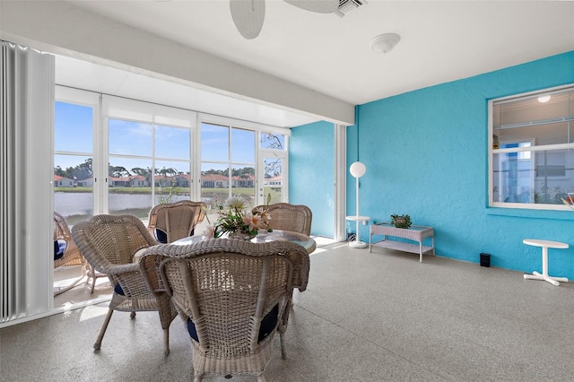4378 Summertree Rd, Venice, FL 34293 - dining room with speckled floor, a textured wall, a water view, and a ceiling fan