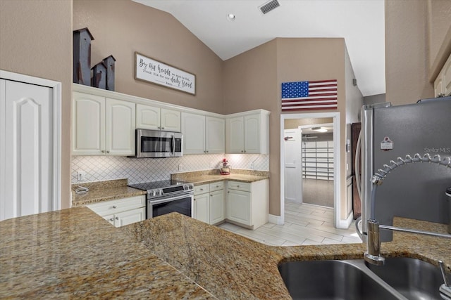 2769 Dode Ave, North Port, FL 34288 - kitchen featuring stainless steel appliances, tasteful backsplash, white cabinetry, and high vaulted ceiling
