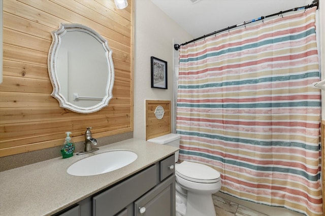 2769 Dode Ave, North Port, FL 34288 - full bathroom featuring vanity, toilet, wooden walls, and a shower with shower curtain
