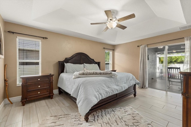 2769 Dode Ave, North Port, FL 34288 - bedroom with a raised ceiling, access to exterior, ceiling fan, baseboards, and wood tiled floors