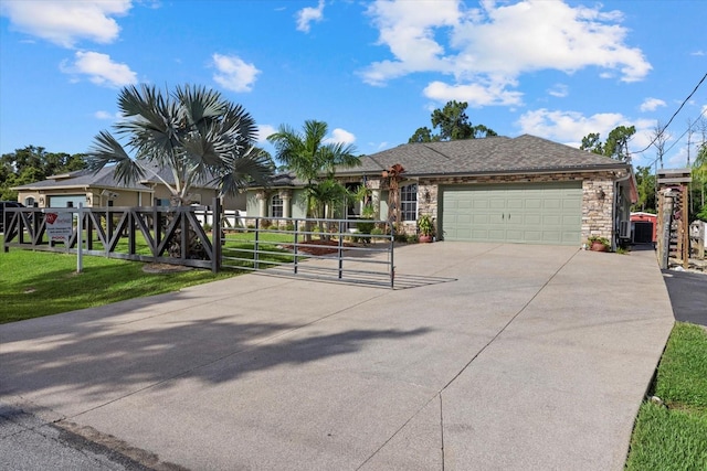 2769 Dode Ave, North Port, FL 34288 - single story home featuring concrete driveway, a gate, a garage, and stone siding