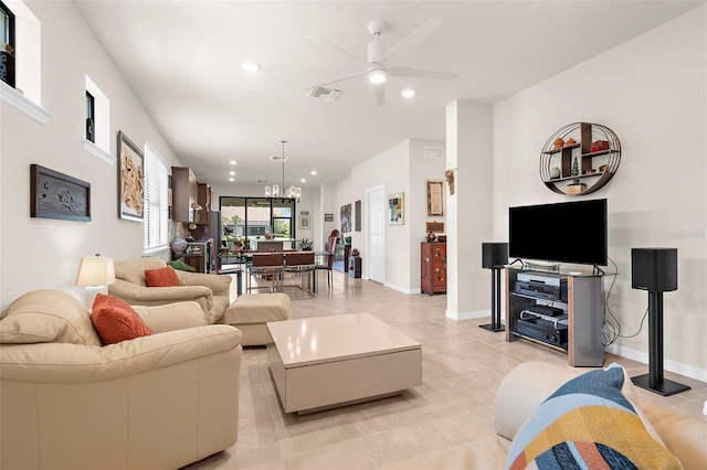 13486 Nobilio St, Venice, FL 34293 - living room with ceiling fan, recessed lighting, light tile patterned floors, and a chandelier