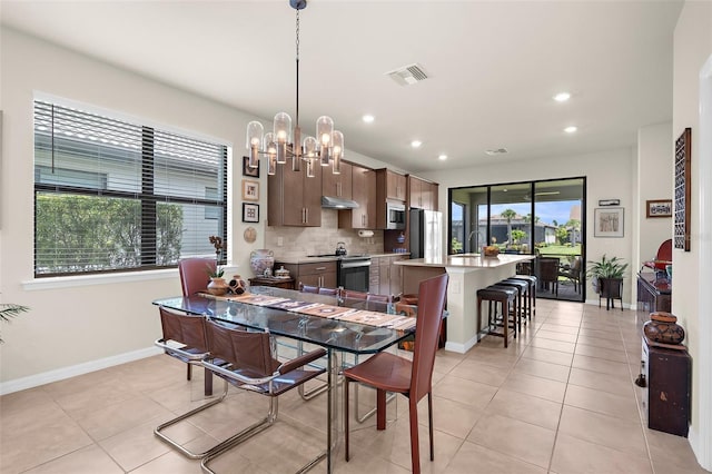 13486 Nobilio St, Venice, FL 34293 - dining space with light tile patterned floors, recessed lighting, and a chandelier
