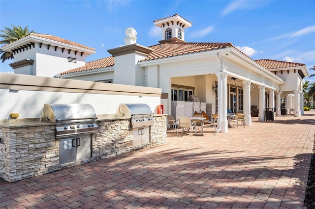 13486 Nobilio St, Venice, FL 34293 - view of patio with an outdoor kitchen and outdoor dining area