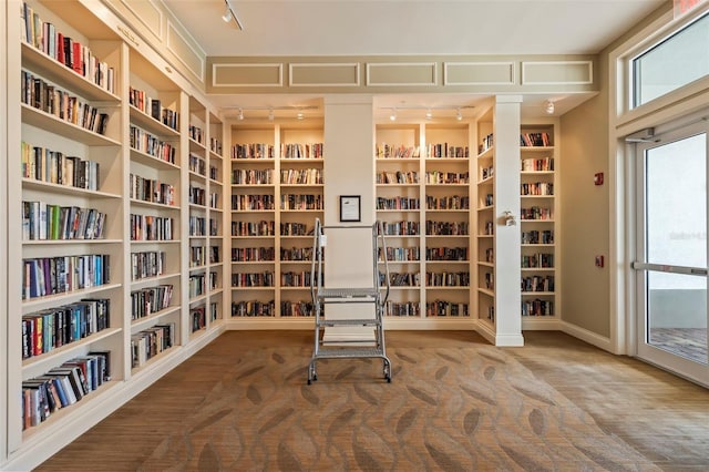 13486 Nobilio St, Venice, FL 34293 - unfurnished room featuring wall of books, track lighting, and built in features