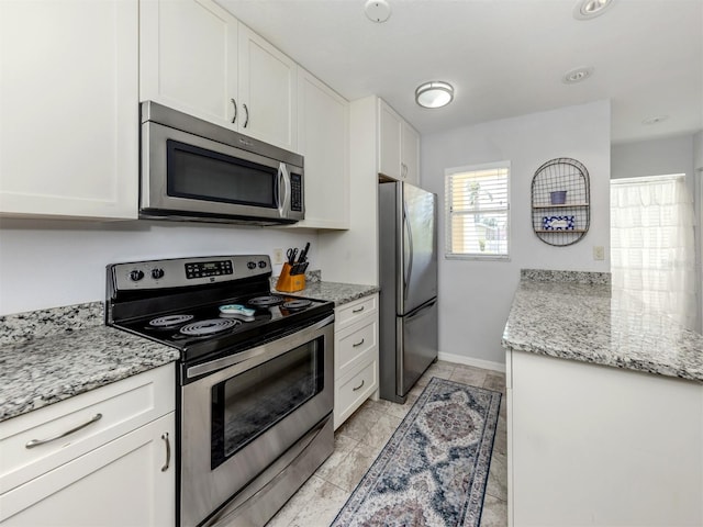 418 Cerromar Ct Unit 158, Venice, FL 34293 - kitchen with appliances with stainless steel finishes, white cabinetry, and light stone countertops