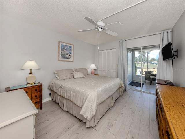 418 Cerromar Ct Unit 158, Venice, FL 34293 - bedroom with access to outside, light wood finished floors, a textured ceiling, a closet, and ceiling fan