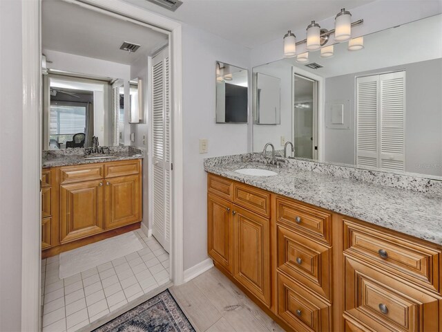418 Cerromar Ct Unit 158, Venice, FL 34293 - bathroom featuring a closet, vanity, baseboards, and tile patterned flooring