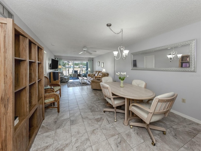 418 Cerromar Ct Unit 158, Venice, FL 34293 - dining room with a chandelier, a ceiling fan, a textured ceiling, and baseboards