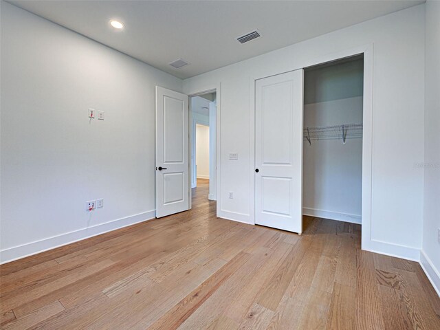 12705 Pinnacle Ln, Venice, FL 34293 - unfurnished bedroom with light wood-style flooring, baseboards, a closet, and recessed lighting