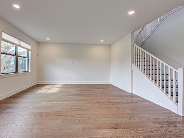 12705 Pinnacle Ln, Venice, FL 34293 - spare room with wood finished floors, stairs, recessed lighting, and baseboards