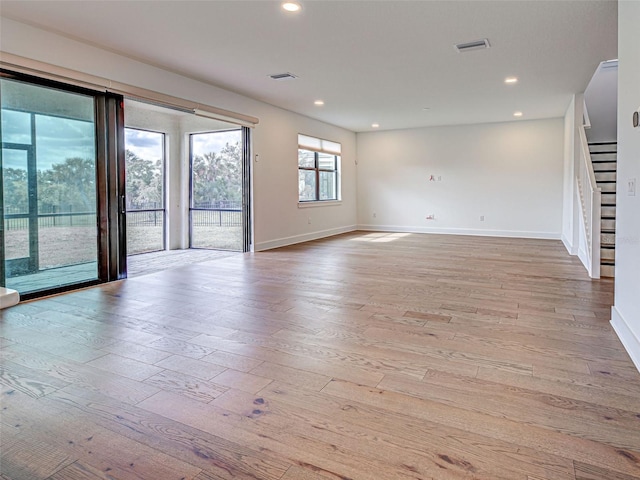 12705 Pinnacle Ln, Venice, FL 34293 - empty room with hardwood / wood-style flooring, baseboards, stairway, and recessed lighting