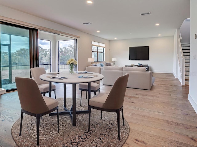 12705 Pinnacle Ln, Venice, FL 34293 - dining area with stairway, light wood-style floors, recessed lighting, and baseboards