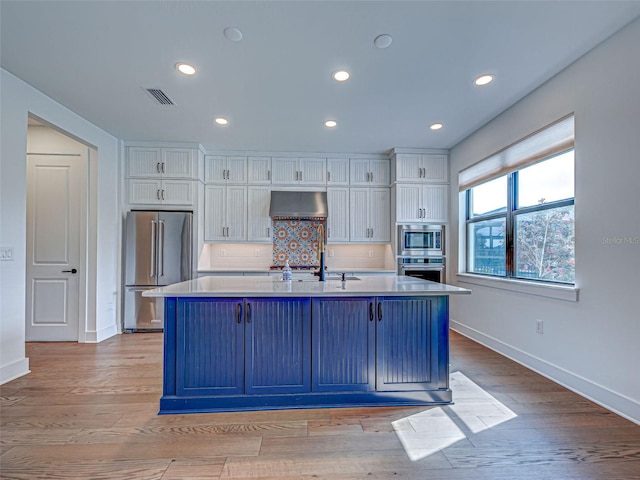 12705 Pinnacle Ln, Venice, FL 34293 - kitchen with appliances with stainless steel finishes, exhaust hood, white cabinetry, baseboards, and recessed lighting