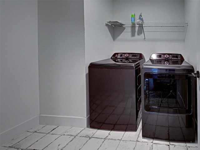 12705 Pinnacle Ln, Venice, FL 34293 - laundry room featuring washing machine and dryer and baseboards
