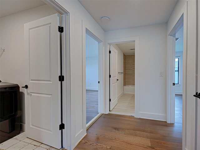 12705 Pinnacle Ln, Venice, FL 34293 - hall featuring light wood finished floors and baseboards
