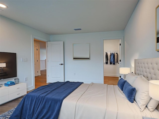 12705 Pinnacle Ln, Venice, FL 34293 - bedroom featuring wood finished floors, baseboards, a walk in closet, and recessed lighting