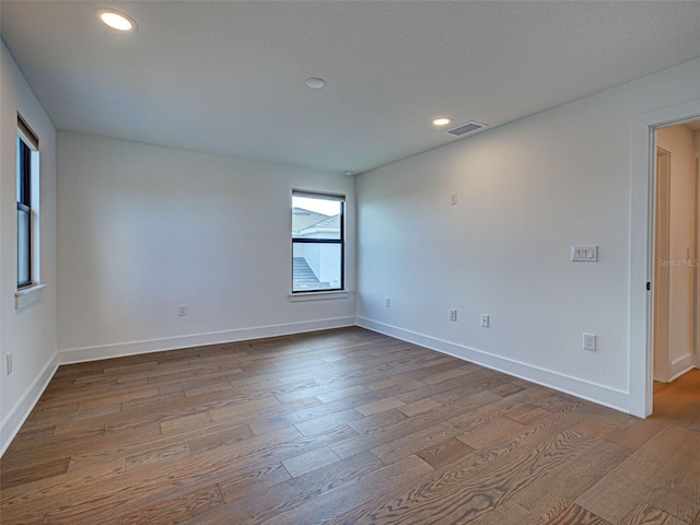 12705 Pinnacle Ln, Venice, FL 34293 - empty room featuring wood finished floors, baseboards, and recessed lighting