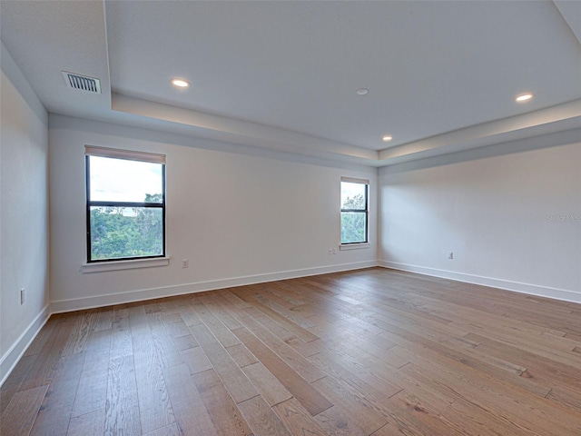 12705 Pinnacle Ln, Venice, FL 34293 - spare room featuring a raised ceiling, hardwood / wood-style floors, recessed lighting, and baseboards
