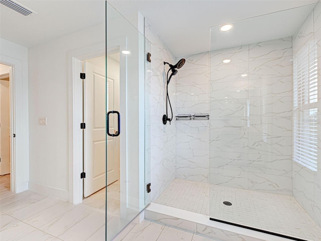 12705 Pinnacle Ln, Venice, FL 34293 - bathroom featuring a marble finish shower, marble look tile flooring, and baseboards