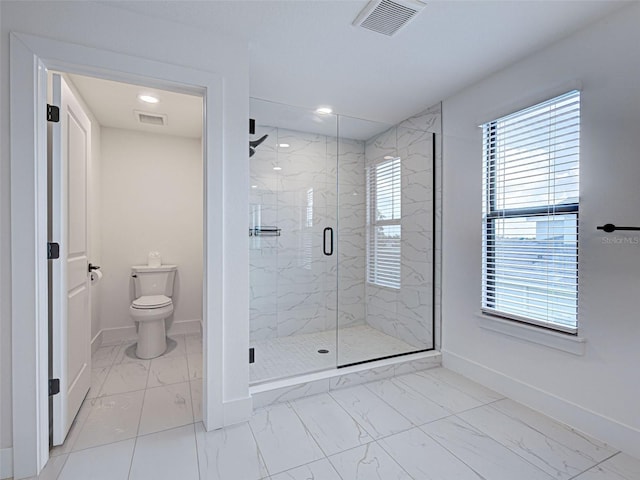 12705 Pinnacle Ln, Venice, FL 34293 - full bath with marble look tile flooring, baseboards, a marble finish shower, toilet, and healthy amount of natural light