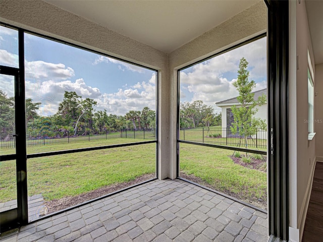 12705 Pinnacle Ln, Venice, FL 34293 - unfurnished sunroom with view of scattered trees