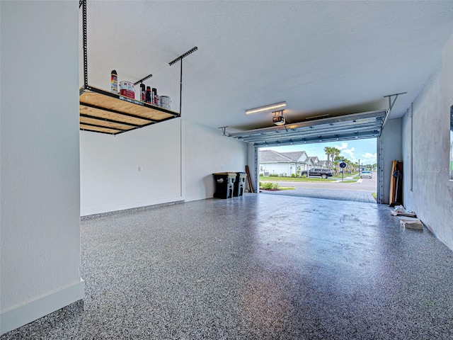 12705 Pinnacle Ln, Venice, FL 34293 - garage with a garage door opener and baseboards