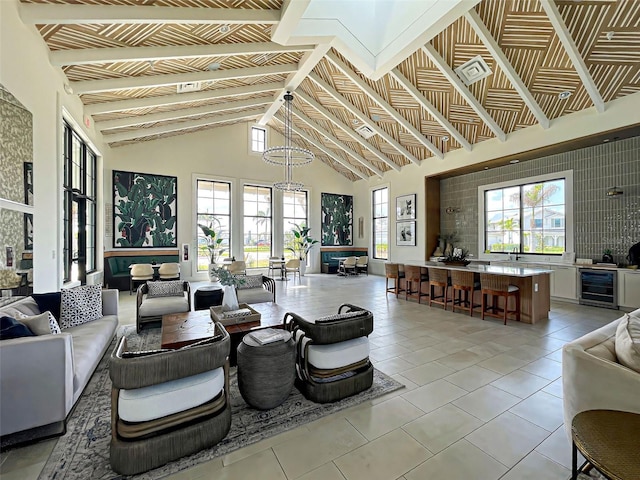 12705 Pinnacle Ln, Venice, FL 34293 - living area with wine cooler, high vaulted ceiling, and light tile patterned flooring