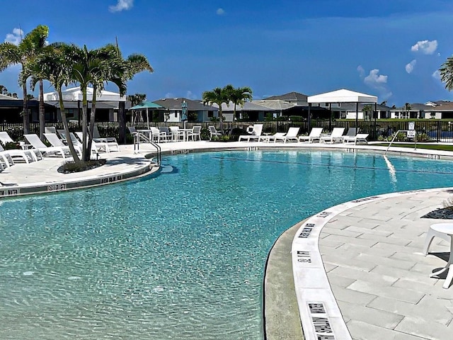 12705 Pinnacle Ln, Venice, FL 34293 - community pool featuring a patio area and a residential view