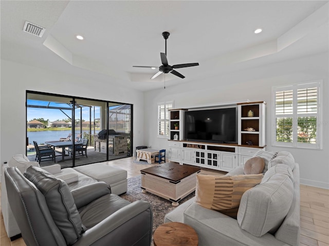 13056 Steinhatchee Loop, Venice, FL 34293 - living room with a tray ceiling, a ceiling fan, light wood-style floors, baseboards, and recessed lighting