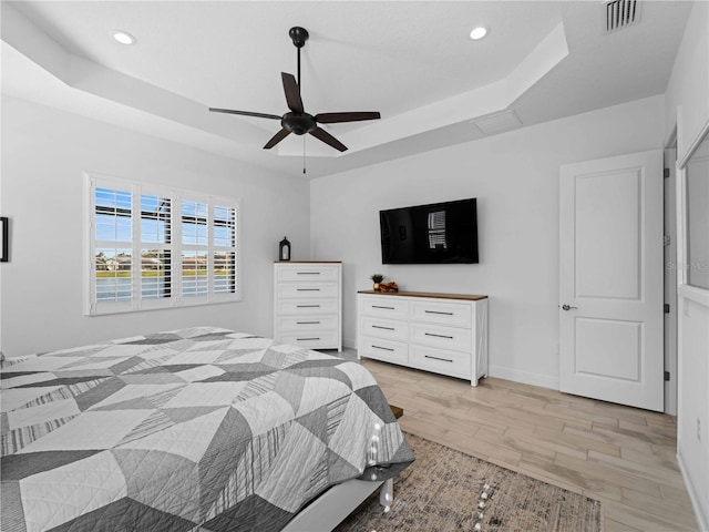 13056 Steinhatchee Loop, Venice, FL 34293 - bedroom with a raised ceiling, light wood-style flooring, recessed lighting, ceiling fan, and baseboards