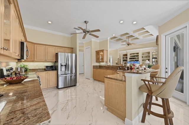5018 Bella Terra Dr, Venice, FL 34293 - kitchen with appliances with stainless steel finishes, a ceiling fan, a peninsula, recessed lighting, and ornamental molding
